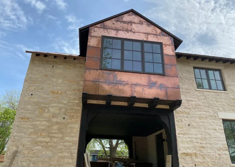 Copper metal panel facade on a stone building for Skylight Installation in Porterville